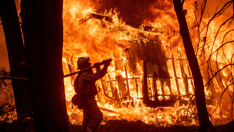A firefighter battles the Camp Fire in California.